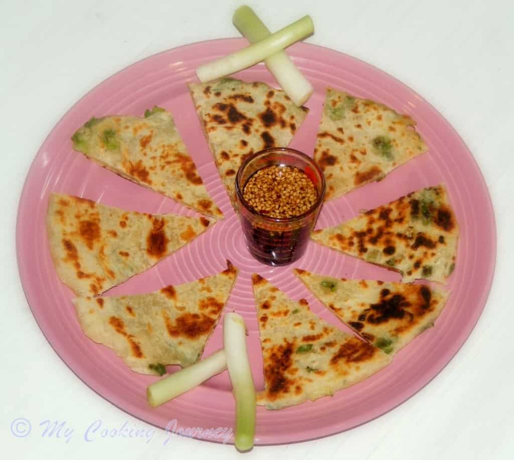Scallion Pancakes cut in a pizza shape and serve in a pink dish 