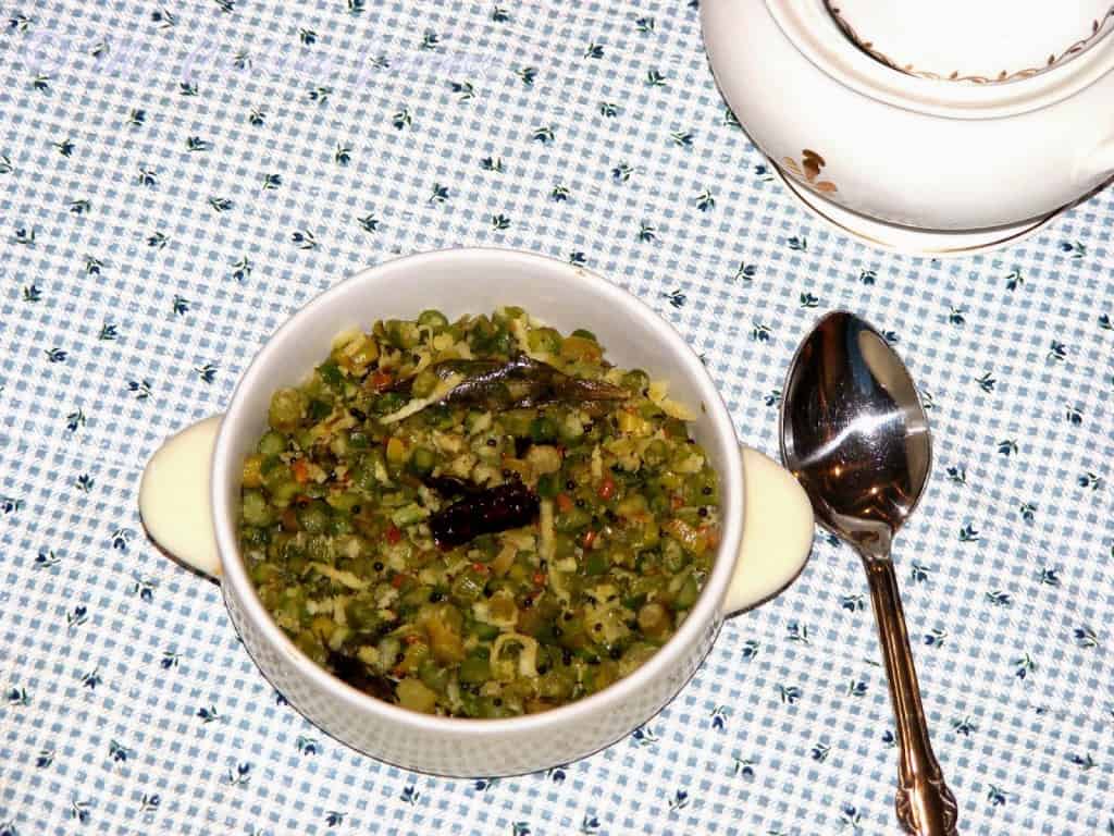 Asparagus poriyal in a white bowl