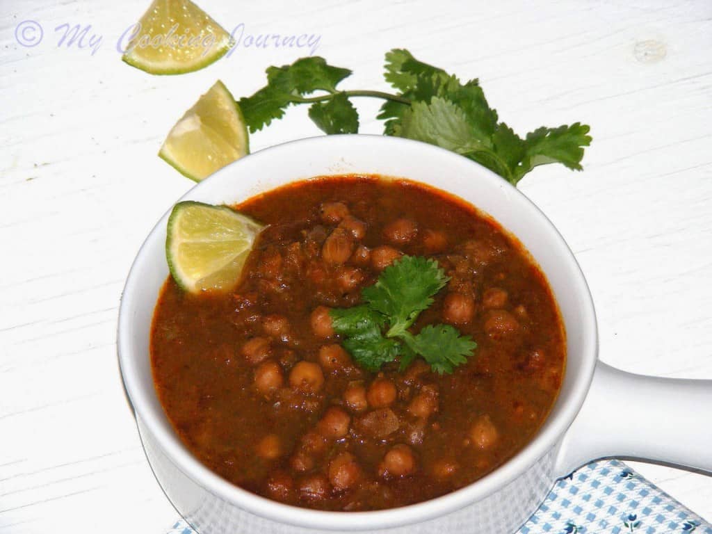 Punjab Channa Masala served in a cup with lemon