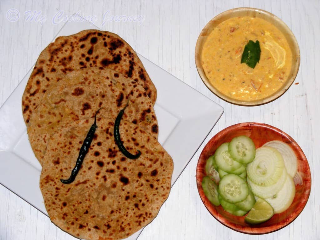 Serve the paratha with curd