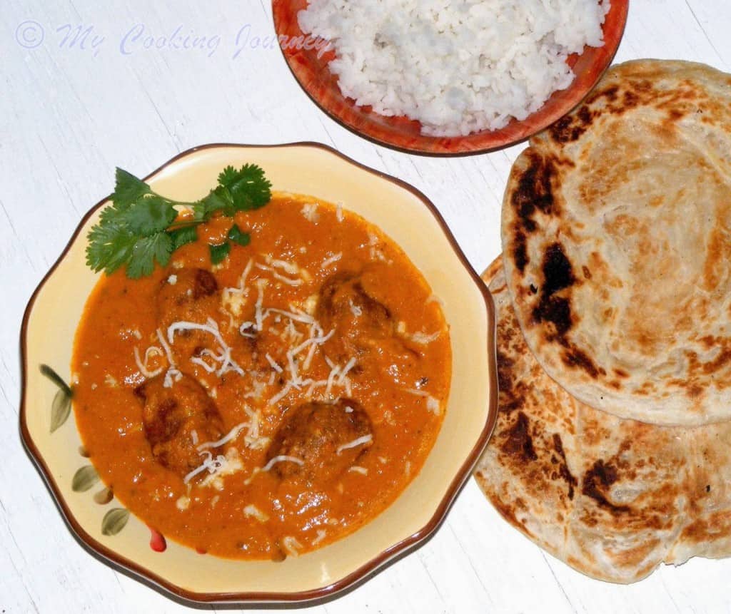 Malai Kofta with paratha and rice on the side