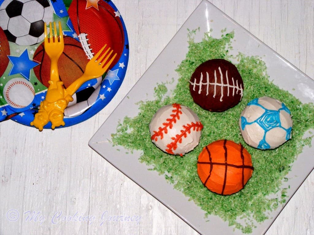 Vanilla Cupcakes served in a plate with Buttercream icing Sports.