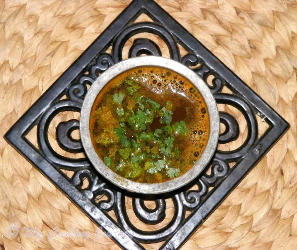 Thakkali Juice Rasam in a steel pot