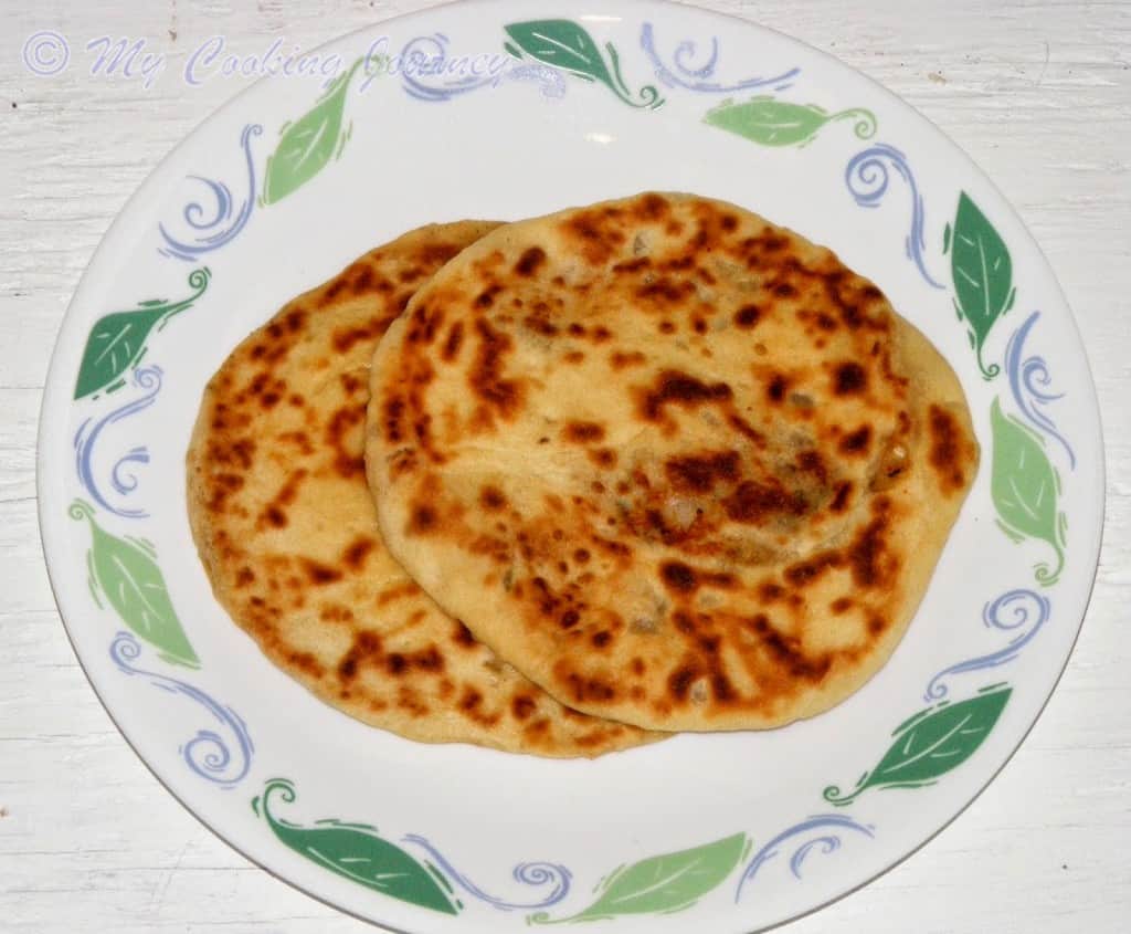 Potato stuffed flatbread on a white plate