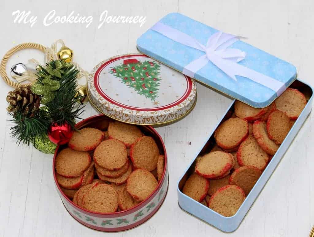 Oat flour and Almond Sables in containers with holiday decorations