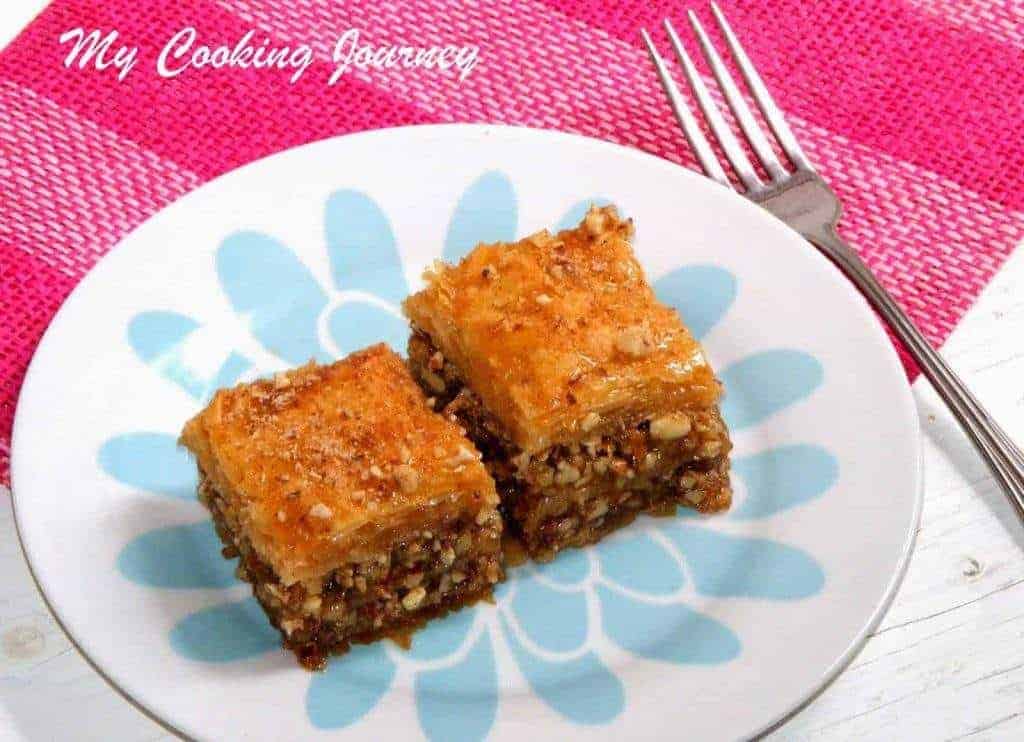 two pieces of Baklava in a plate with fork on side