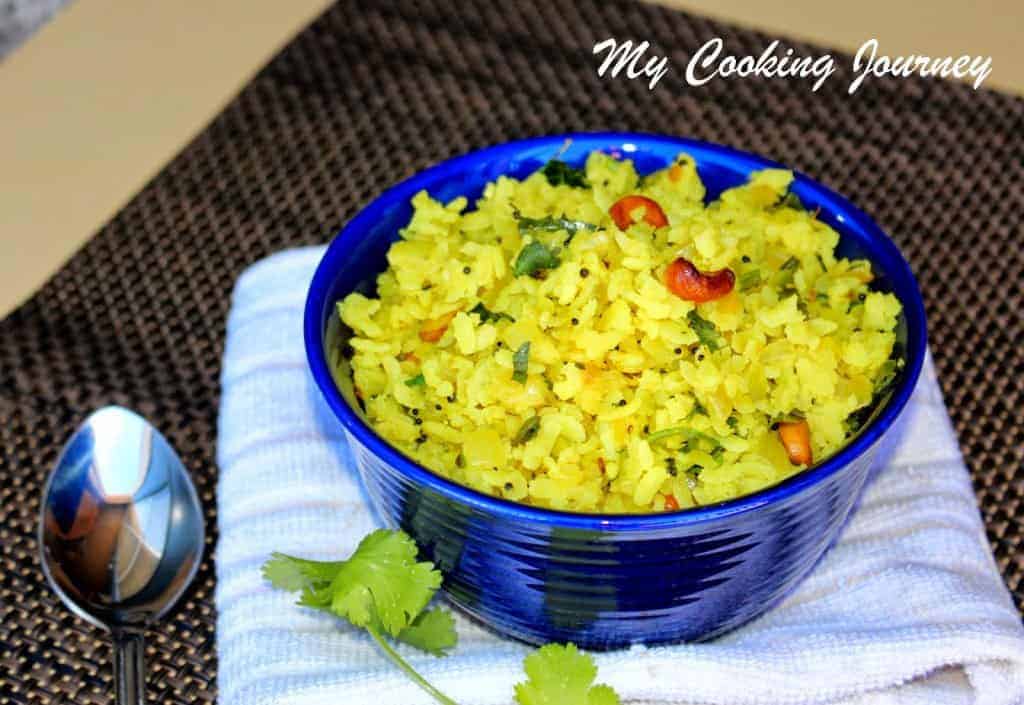 Aval Upma in a blue bowl with spoon