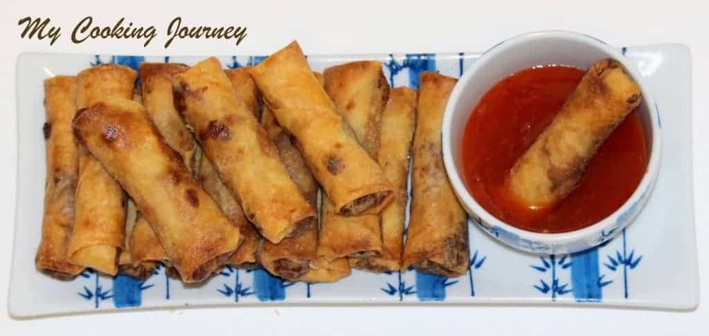 Vegetable and Tofu Spring Rolls in a plate with dipping sauce in a bowl