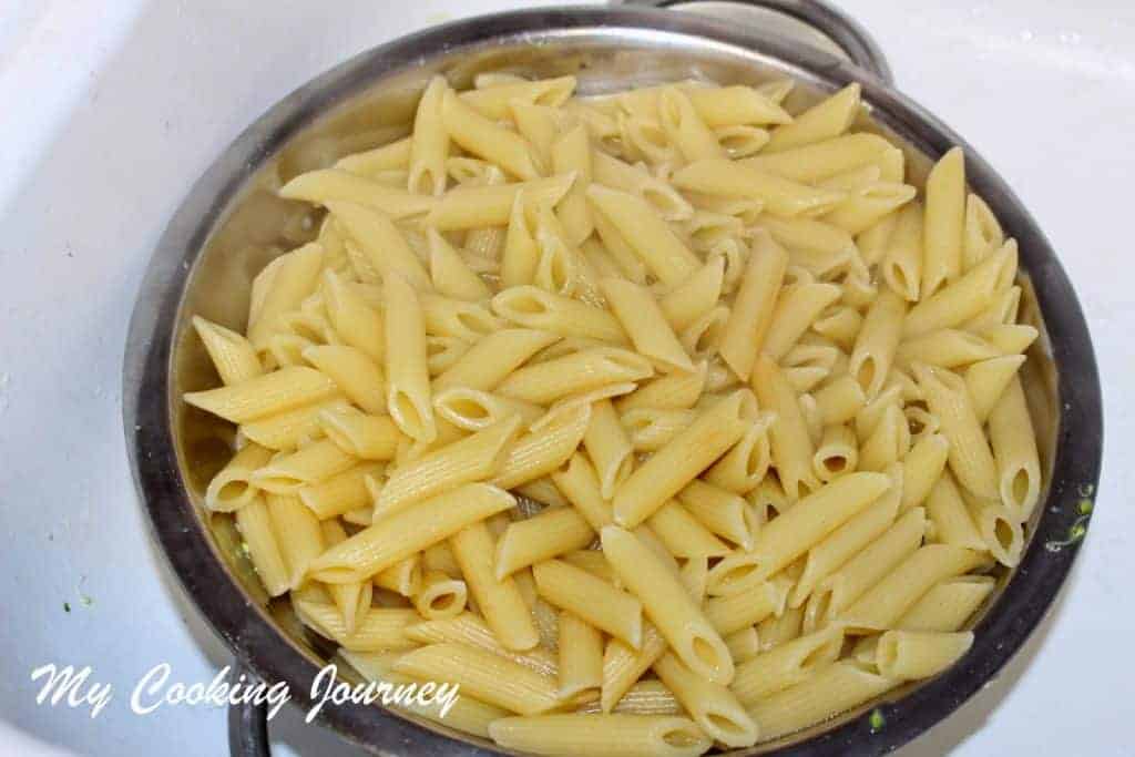 Straining the boiled pasta.