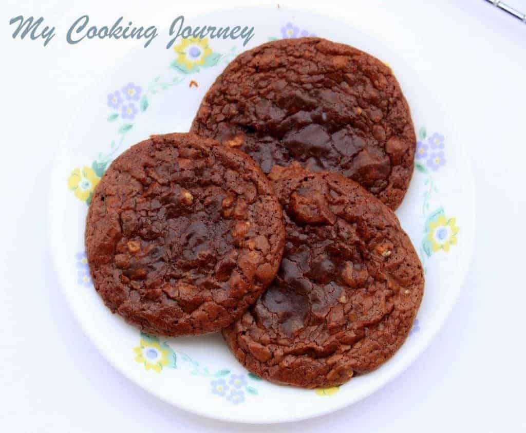 Three Gluten free Chocolate Pecan Cookies are kept in a dish