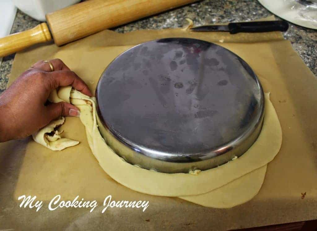 Using a plate to cut the dough