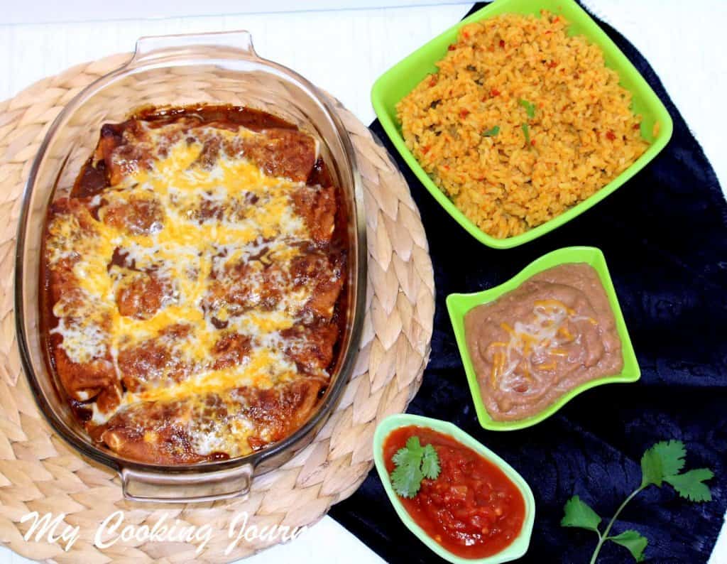 Spinach Enchiladas serving with rice and beans