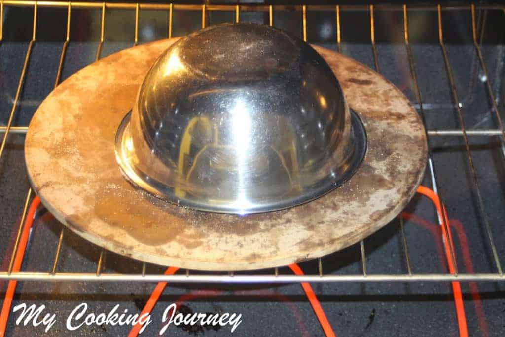 Baking the dough by covering the bowl in oven