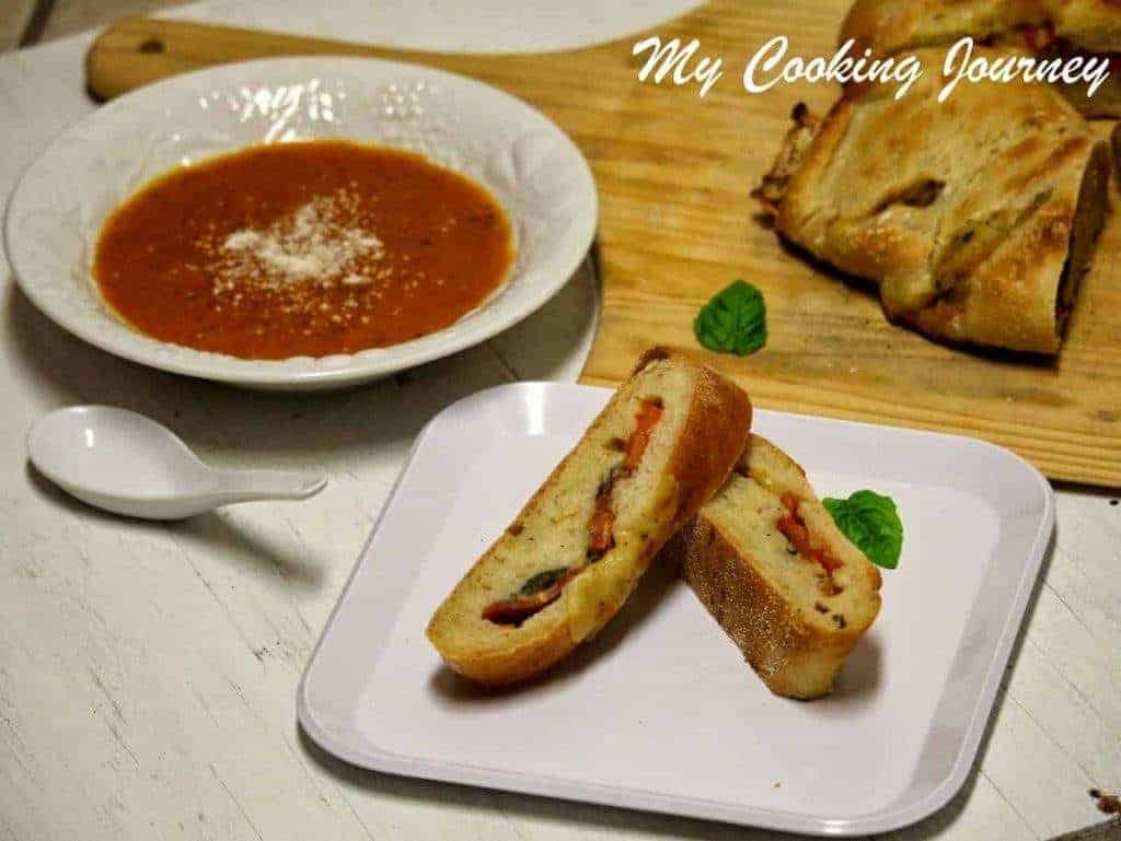 Tomato Mozzarella and Basil stuffed Baguette in a dish served with soup
