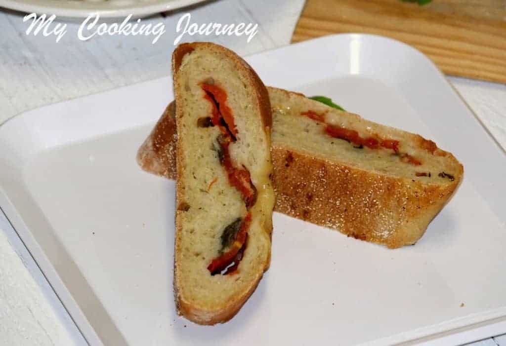Stuffed Baguette sliced in a white dish