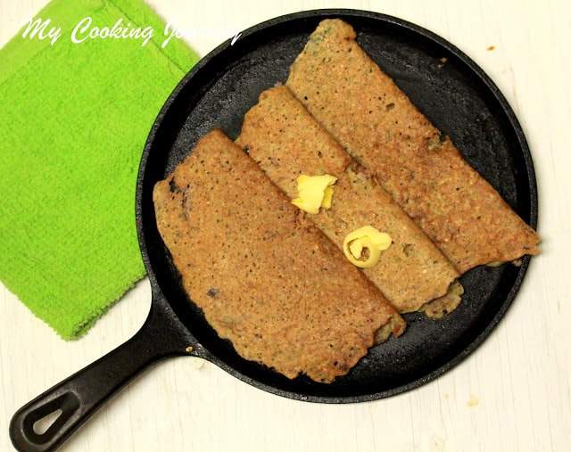 Adai Made With Brown Rice in a cast iron pan.