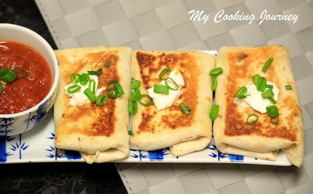 Vegetarian Chimichangas  with sour cream and green onions on top