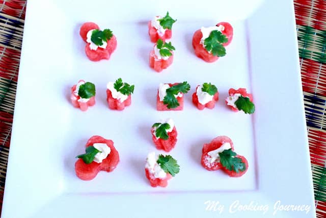 Watermelon bites served in a tray with cilantro