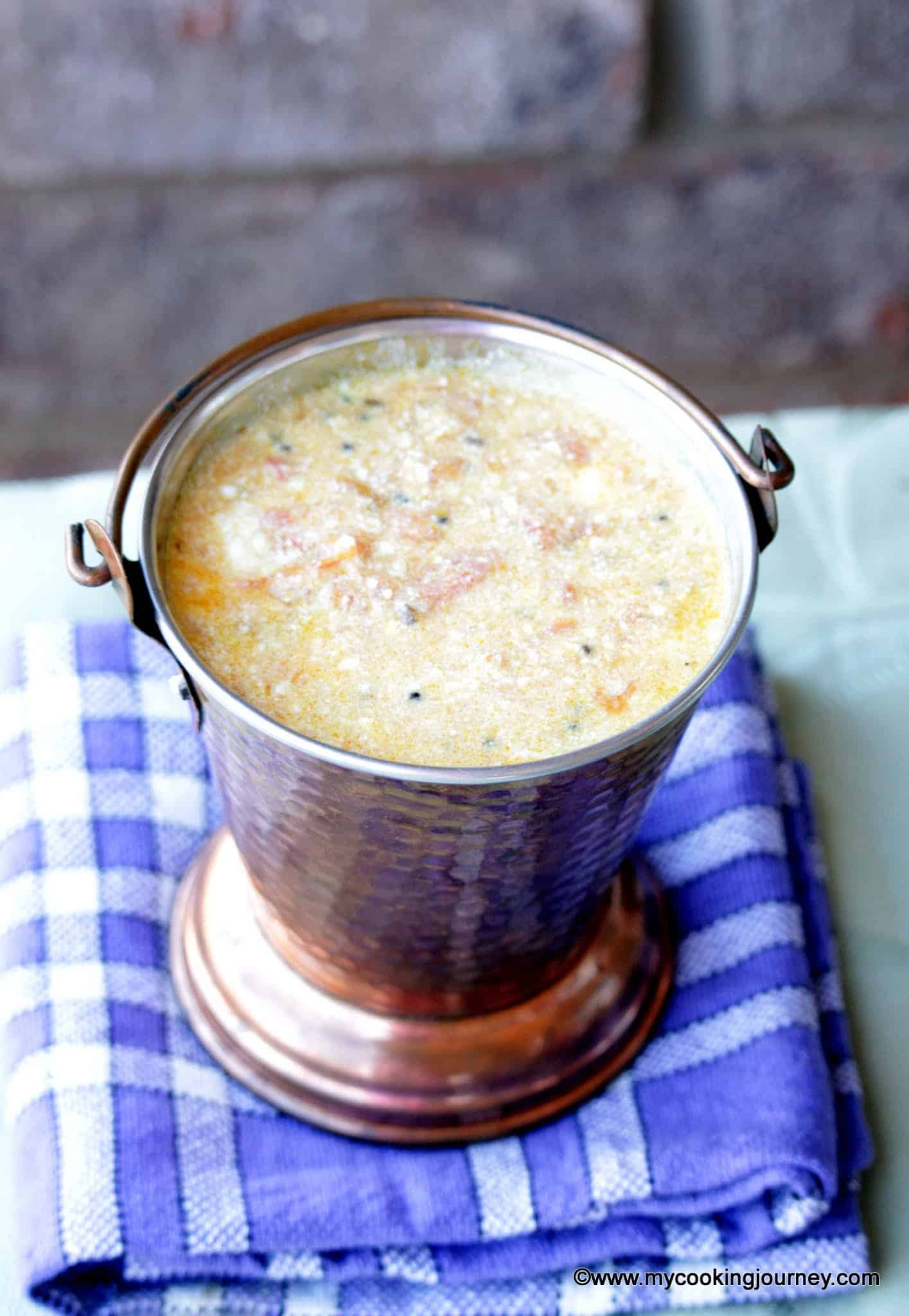 tomato raita in a brass pot