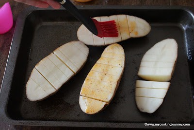 brushing butter/oil on sliced potato
