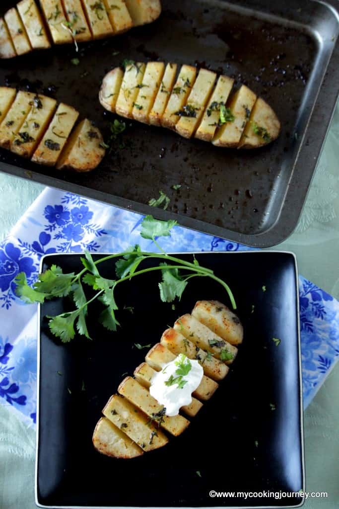 baked sliced potatoes on a tray and in a plate