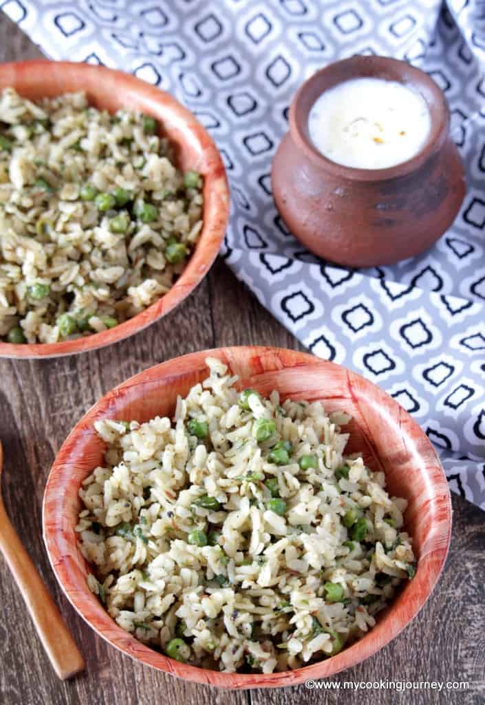 Flattened Rice with Green Peas in brown bowl