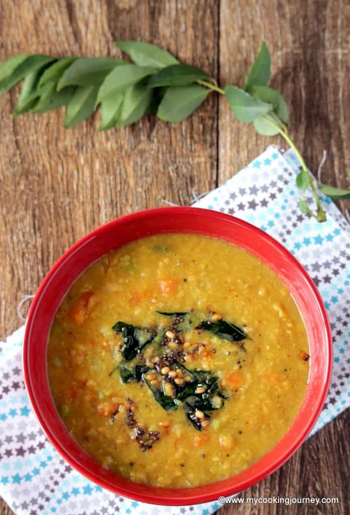 Vegetable Poricha Kootu in a red bowl