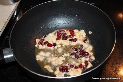 Frying cashews and cranberries