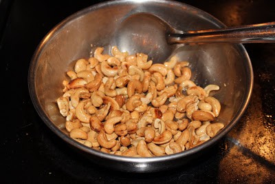 Roasting cashew nuts in steel kadai