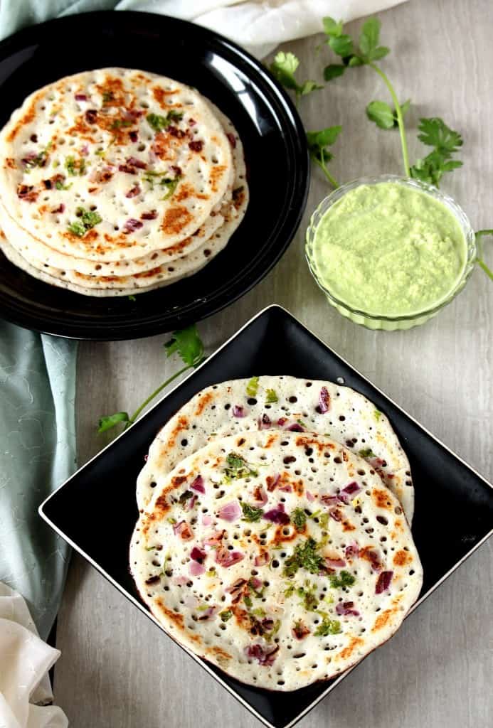 Onion Oothappam in a round and square plate with chutney on the side