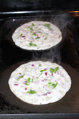 Sprinkle onions, cilantro, chilies and carrots on the batter while cooking.