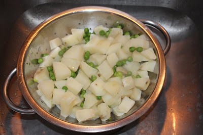 Cooked potatoes with peas
