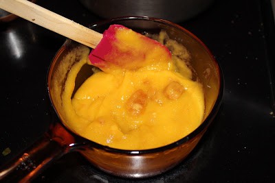 Heating jackfruit pulp in a pan