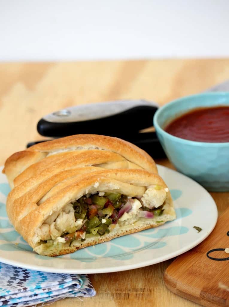 Vegetable Stuffed Braided Bread cut in to half on a dish