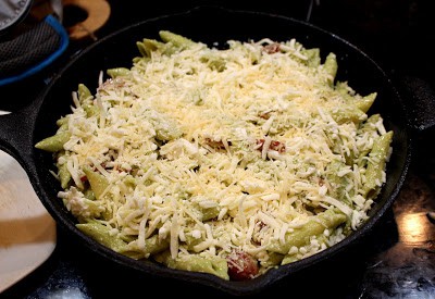 Adding Mozzarella cheese and Parmesan cheese in pasta.