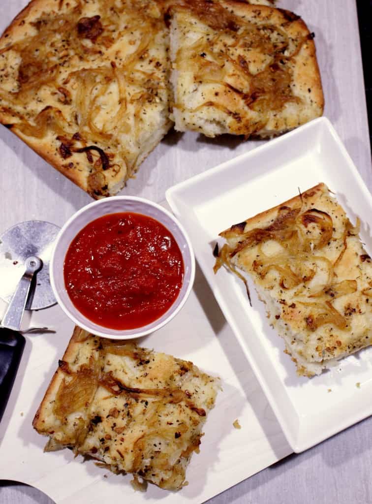 Focaccia with Herbed Oil and Caramelized Onions with some sauce 