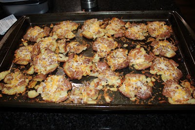 cheese sprinkled on smashed roasted potatoes