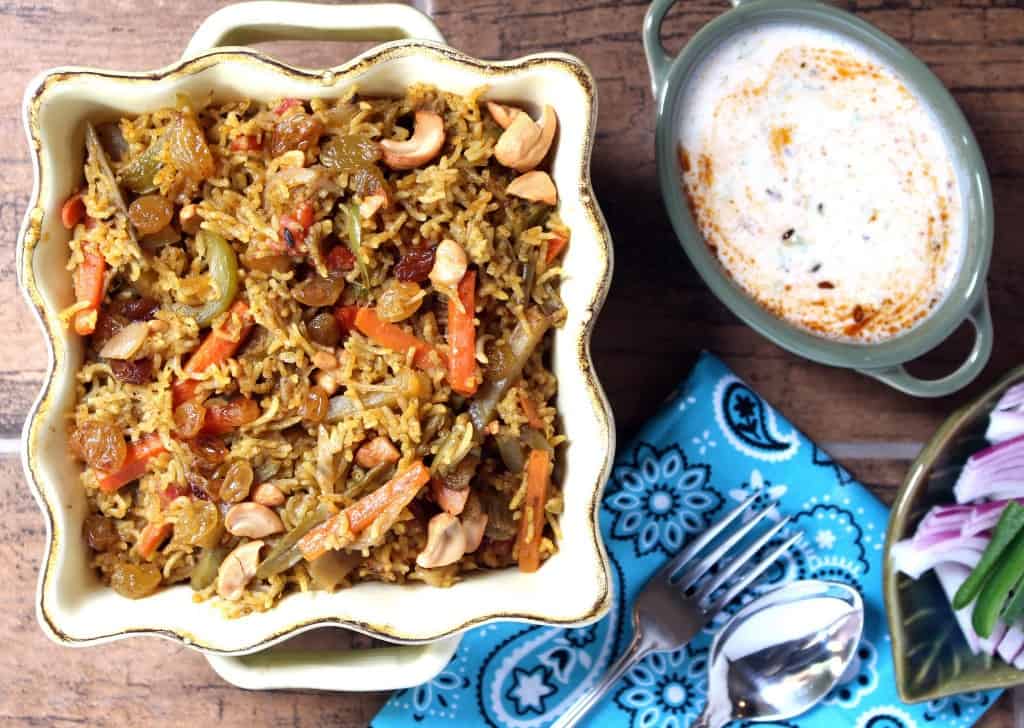 Vegetable Biriyani with other things salad and spoon