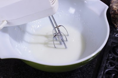 Beating sugar with hand mixer.