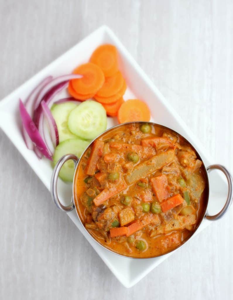 Kadai Vegetable Gravy with cucumber, Onion and carrot on the side - top view