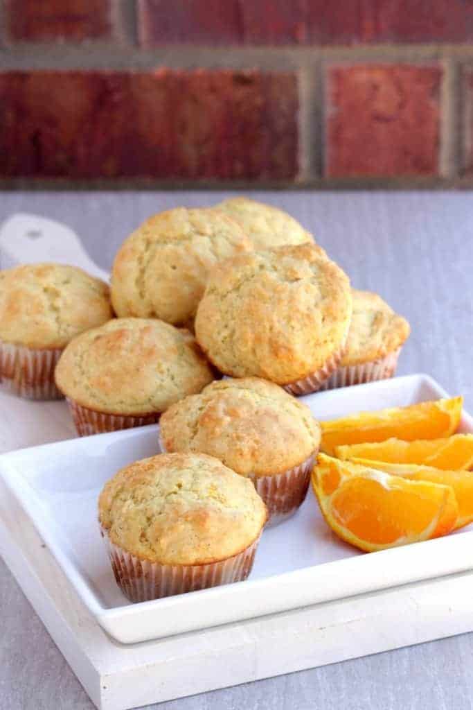 Orange Muffins - Stacked on side and in a plate with orange