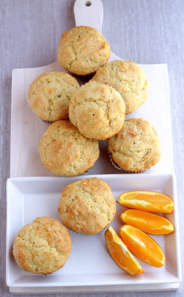 Egg less Orange Muffins stacked in plate and wooden board