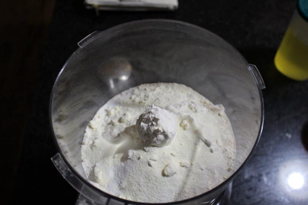 flour, yeast, sugar, salt and milk powder in a food processor bowl