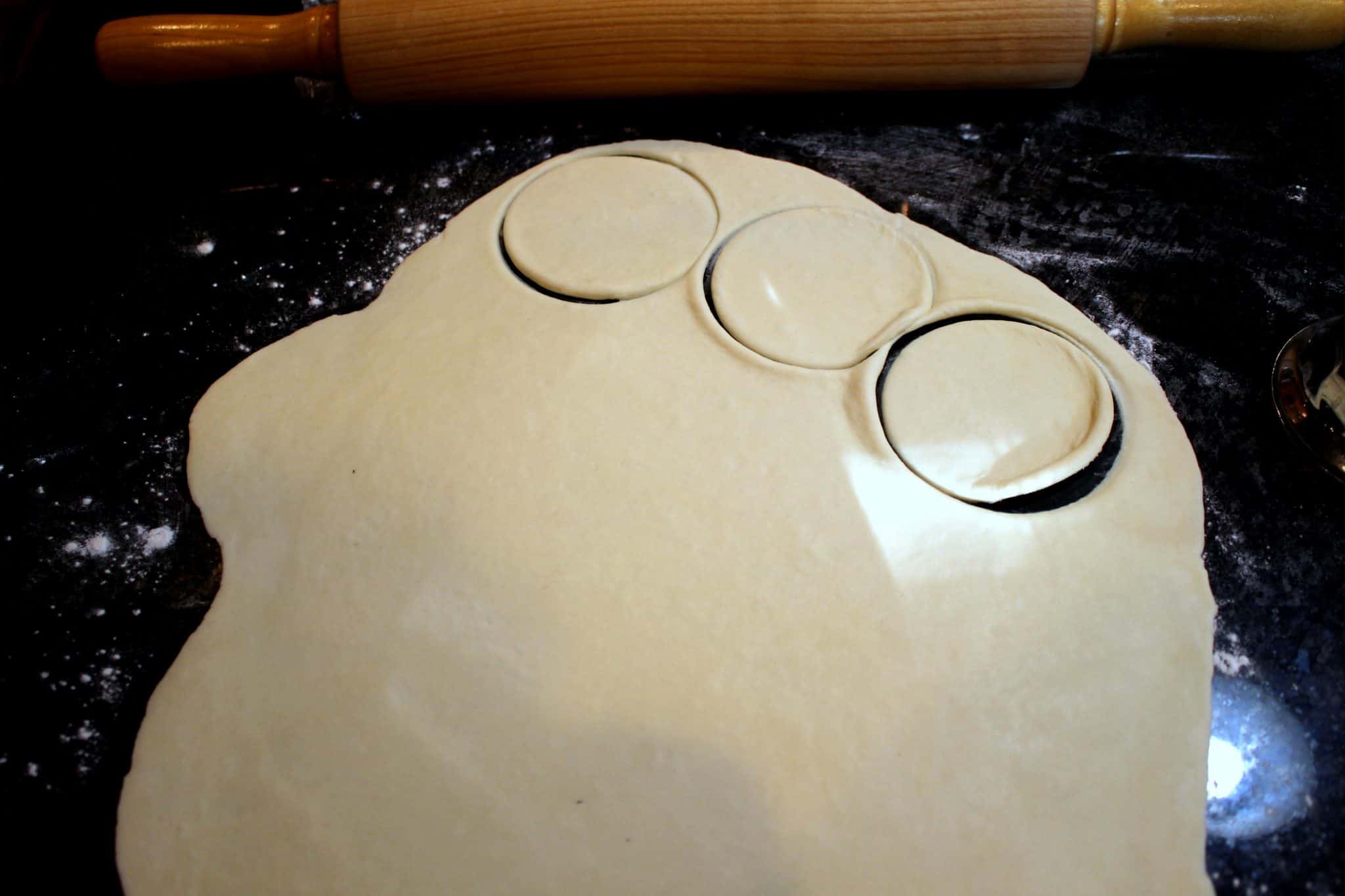 rolling and cutting the empanada dough