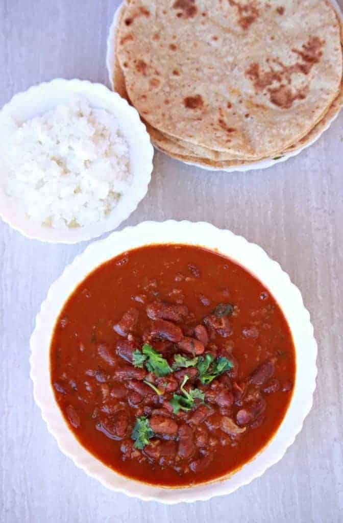 Instant Pot Rajma Masala in a white bowl with white rice and roti