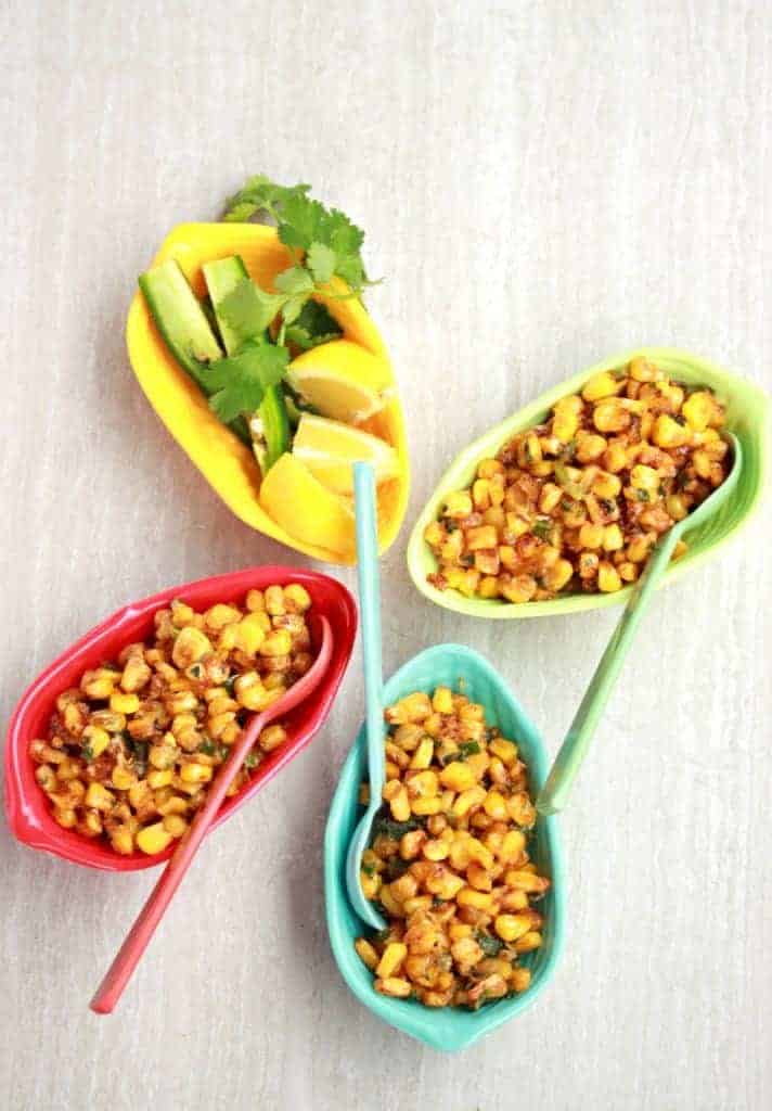 Creamy Mexican Street Corn Salad in three bowls with sides