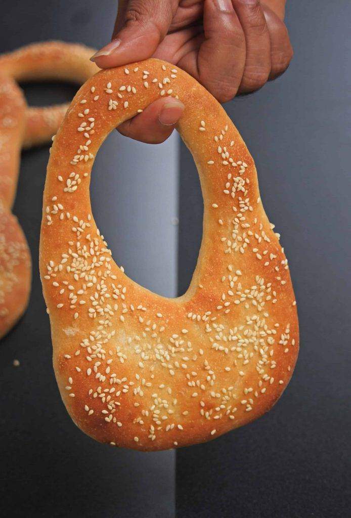 Ka'ak Bread hanging from finger.
