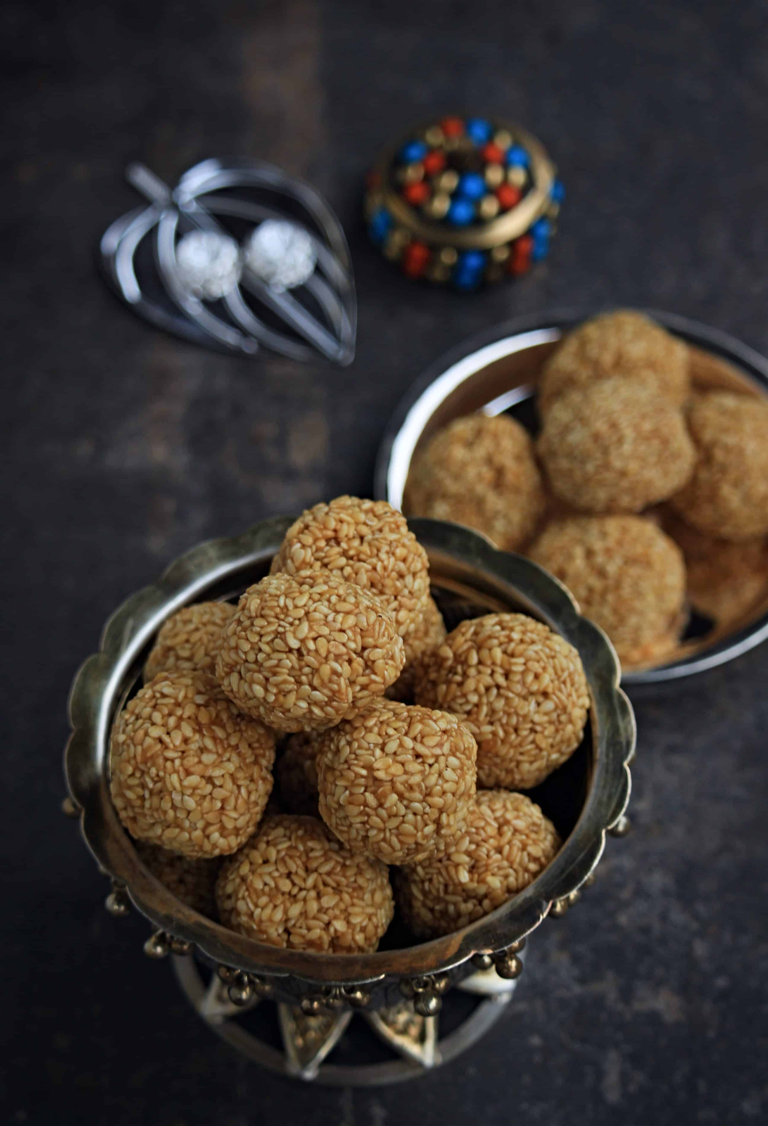 Sesame Seed Ladoo in cup and in a plate in background