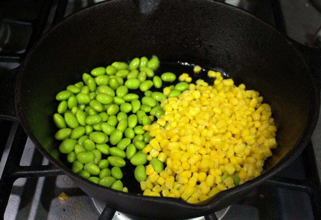 Rossting corn and edamame in cast iron skillet