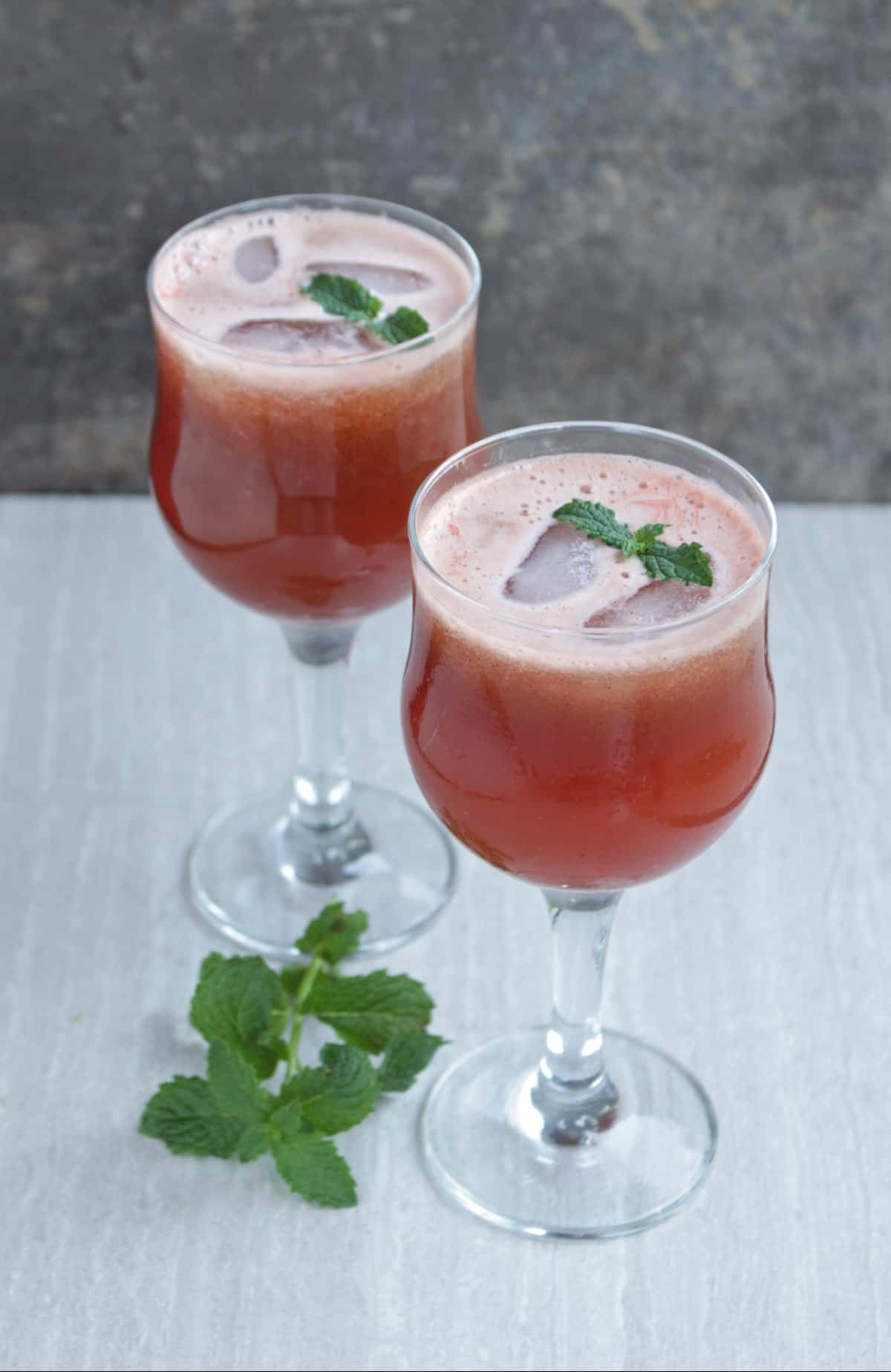 Watermelon juice with mint as garnish in 2 glasses